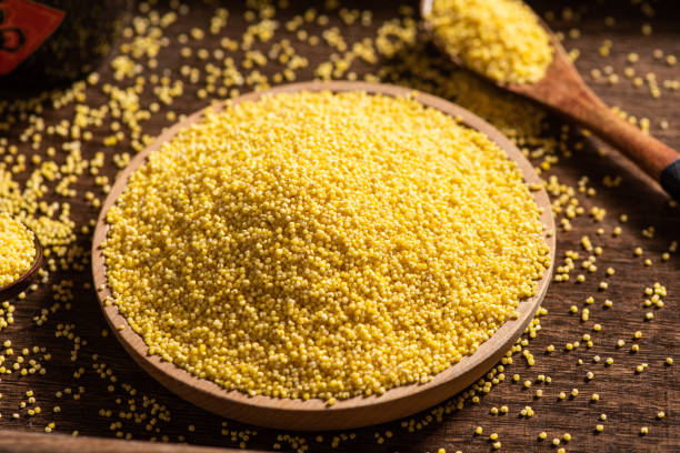 istock Raw dry millet in a plate on wooden table. 1402817162