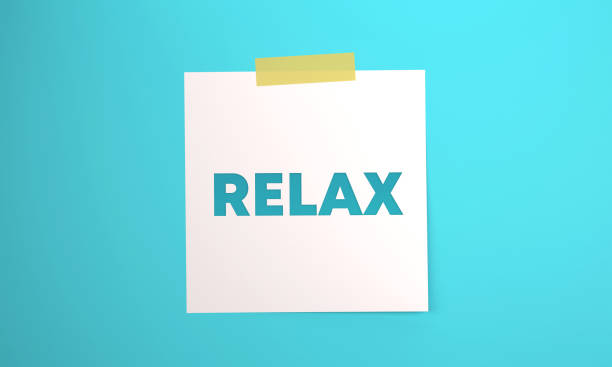 Note paper with Relax message attached to blue background with tape. Communication concept.