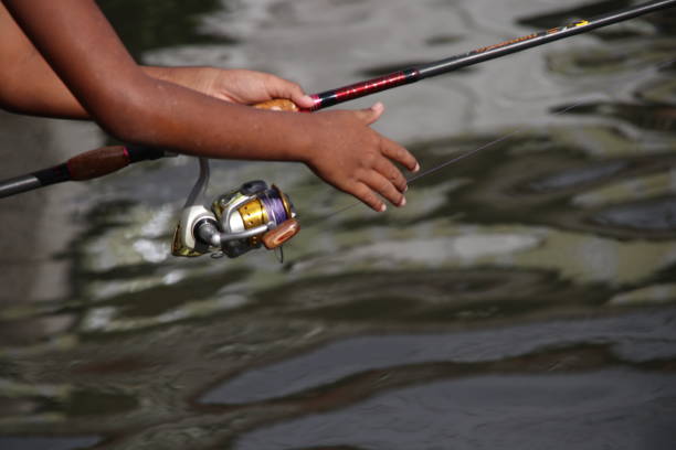 istock Hand is catching fishing rod. 1402817965