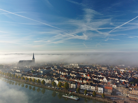 Kampen city view at the river IJssel during a foggy sunrise