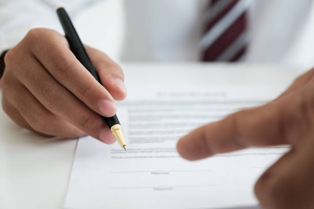 Close up businessman signing contract, partnership agreement, making deal Close up businessman signing legle agreement document contract with partnership agreement after successful negotiation deal. men close up 20s asian ethnicity stock pictures, royalty-free photos & images