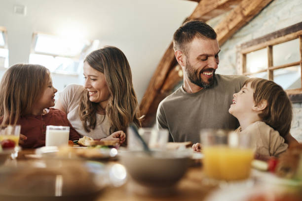 istock Young family talking during breakfast at dining table. 1402821594