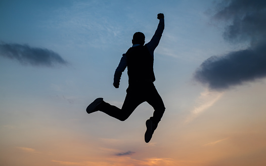 man jump high silhouette full of energy against sunset sky, energy.