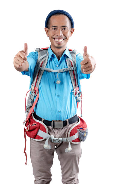 Asian man with a beanie hat and a backpack showing a thumb up gesture isolated over white background