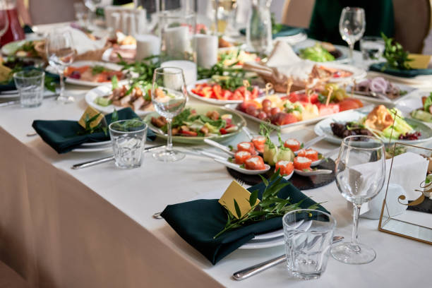 istock Table setting with sparkling wineglasses, plate with green napkin and cutlery on table, copy space. Place set at wedding reception. Table served for wedding banquet in restaurant 1402825918
