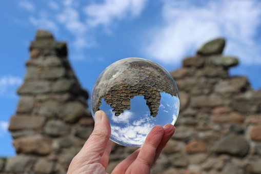 Old ruins reflected in glass ball