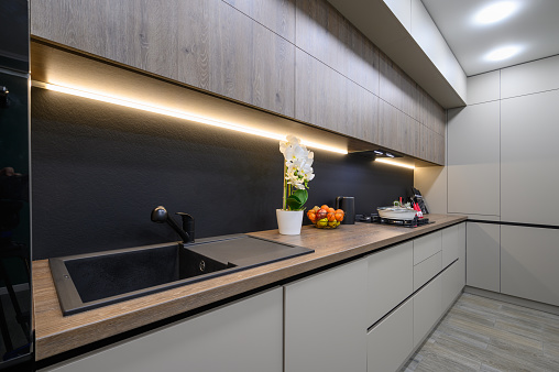 Trendy grey modern kitchen interior showcase with minimalistic furniture and some Christmas decoration at worktop