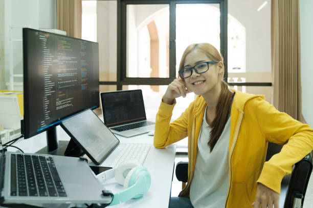 Young programmer or IT specialist satisfied with her work done. stock photo