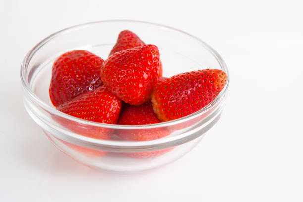 Glass bowl of fresh strawberry on white