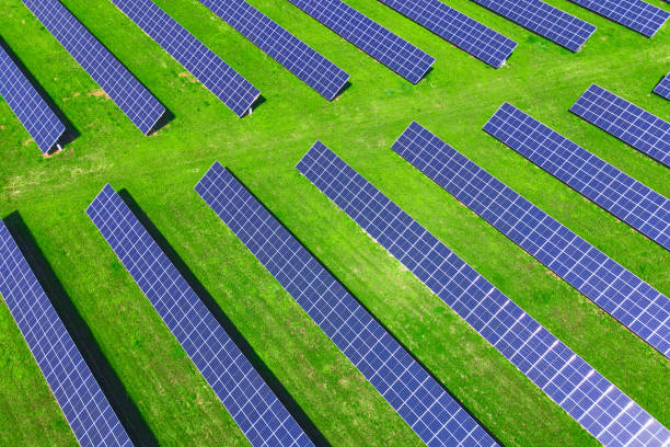 istock Solar panels in green field, aerial view 1402829964