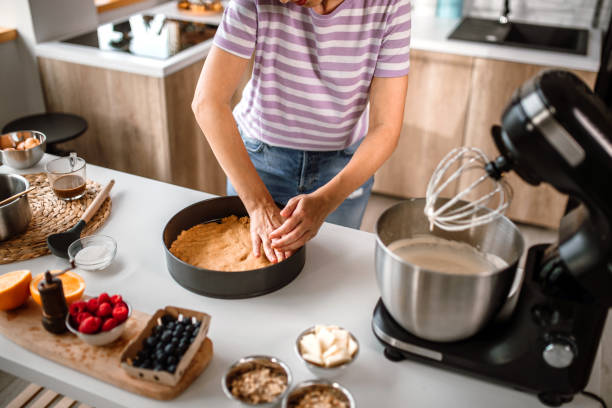 istock Woman shaping cake crust in cake mold 1402830173
