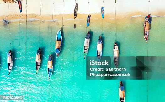 istock Aerial top view of the  local boat near the lagoon seashore as the tropical island in a coral reef ,blue and turquoise sea  background 1402830593