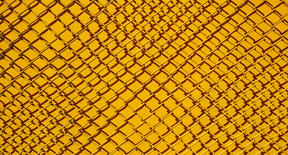 Yellow steel wire mesh pattern texture background.