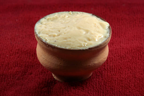 istock Mishti Laal doi or dahi or bengali sweet curd isolated on red background 1402832369