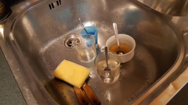 istock Dirty Kitchen Sink Many Glasses 1402833476