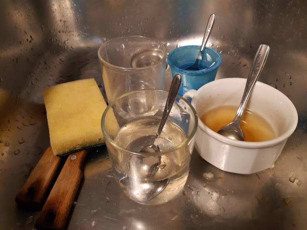 istock Dirty Kitchen Sink Many Glasses 1402833482
