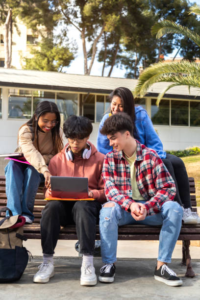 istock Group of multiracial college student doing university research homework and studying together on campus. Vertical 1402835307