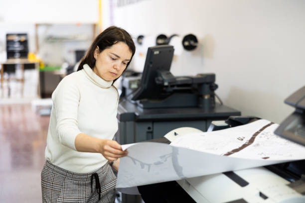 istock Woman working in publishing facility 1402835642