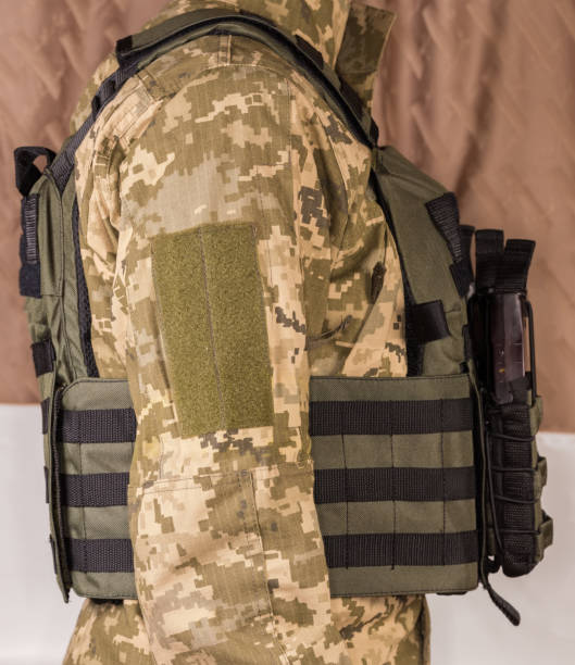 istock Bulletproof vest with magazine pouches dressed on soldier, back side 1402836760