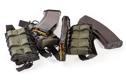 Textile military tactical pouches for cartridge magazines for fasten to combat unloading vest or bulletproof vest, three loaded magazine separately on a white background