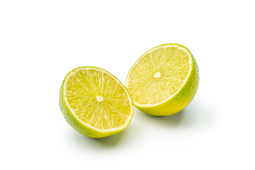 Close-up of two lime halves isolated on white  background