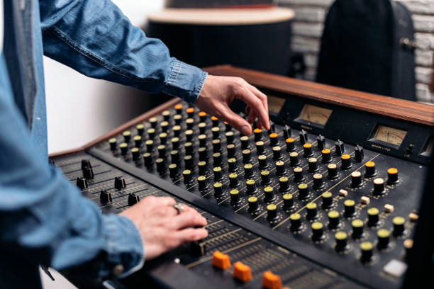 Metropol Studios_Property.jpg, Metropol Studios_Sylvain, Metropol Studios_Property Screens.jpg Stock photo of unrecognized person using panel control in professional music studio. media occupation stock pictures, royalty-free photos & images