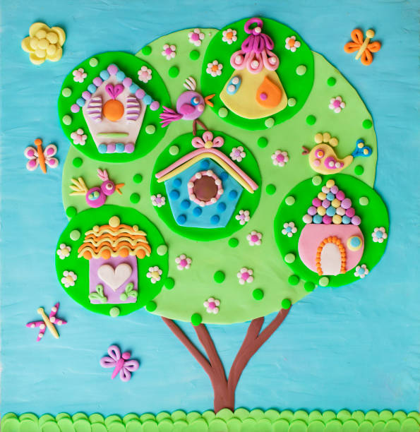 istock Clay handmade childish  illustration tree with birdhouses with birds, chips, nestlings singing songs spring time. 1402840982