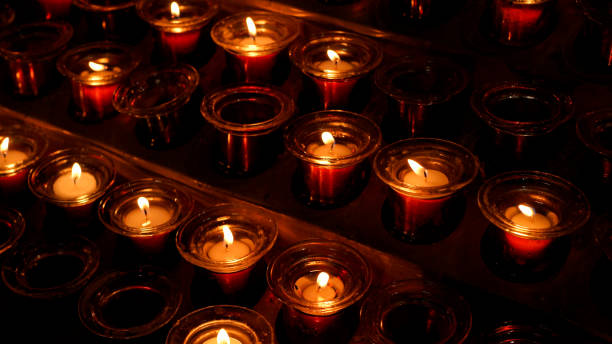 istock Candles burning in a catholic church 1402841003