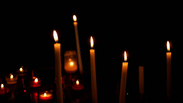 istock Candles burning in a catholic church 1402841020