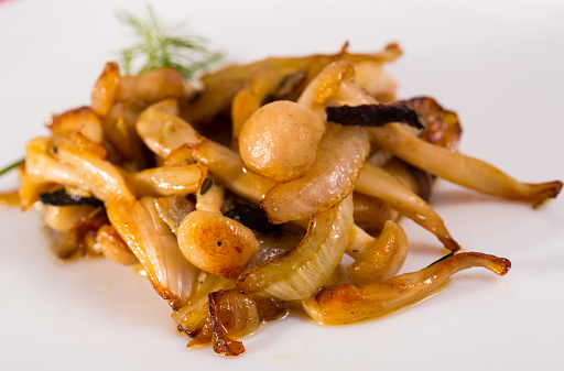 Delicious fried forest mushrooms decorated with chives and dill