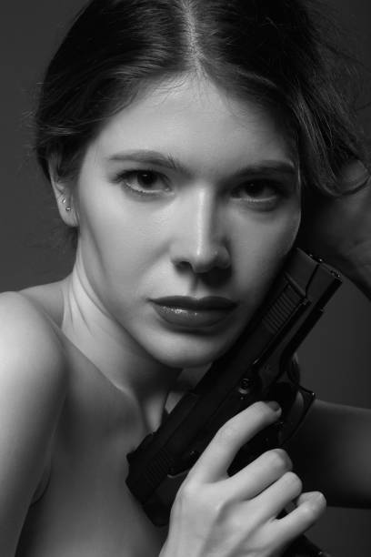 istock woman with gun 1402841874