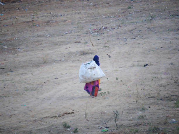 Pushkar, Rajasthan India - November 13, 2021 : ragpicker or chiffonnier is someone who makes a living by rummaging through refuse in the streets to collect material for salvage.