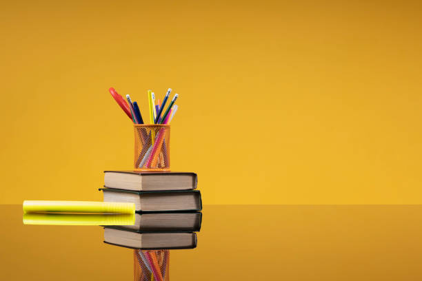 istock School accessories as a back to school concept. Writing materials on a stack of old books and a yellow marker as a background with free space for the website of a school, institute, university, an article about school education 1402843925