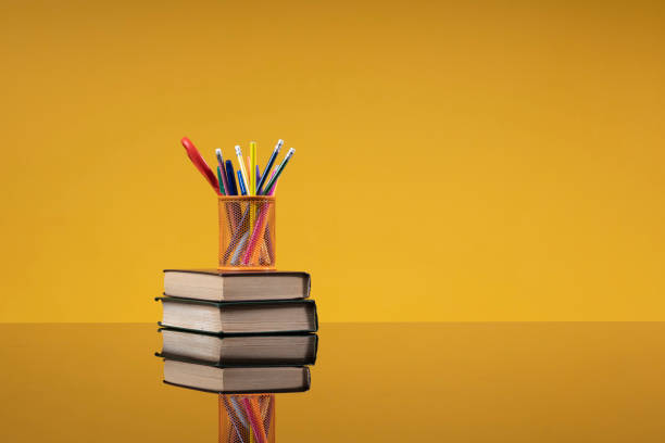 istock School accessories as a back to school concept. Writing materials on a stack of old books as a background with free space for the website of a school, institute, university, an article about school education 1402843963