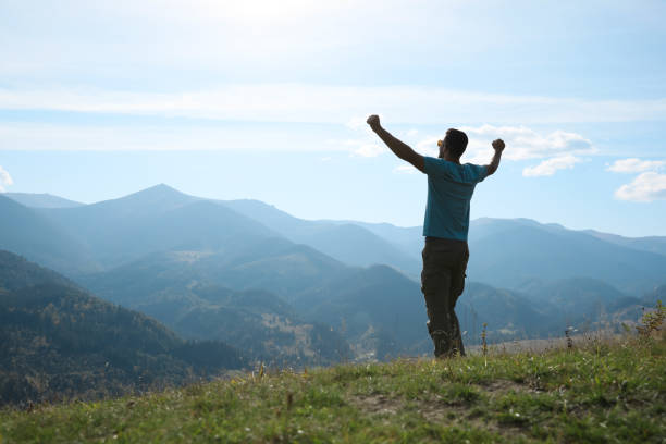 istock Happy tourist in mountains on sunny day 1402844608