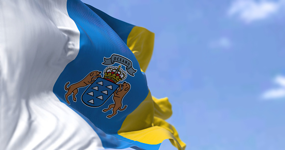 The Canary Islands flag waving in the wind on a clear day. The Canary Islands are a Spanish region and archipelago in the Atlantic Ocean, in Macaronesia