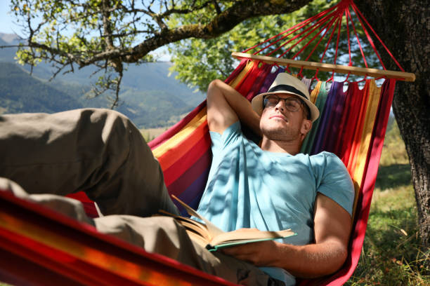istock Man resting in hammock outdoors on sunny day 1402846606