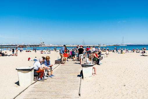 Poland, Sopot - people chilling on the Sopot beach. Blue cloudless sky is on the background.