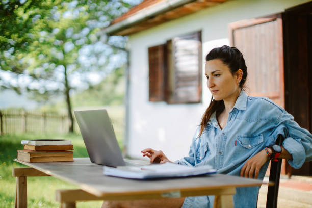 istock woman finishing work outside the weekend house 1402848015