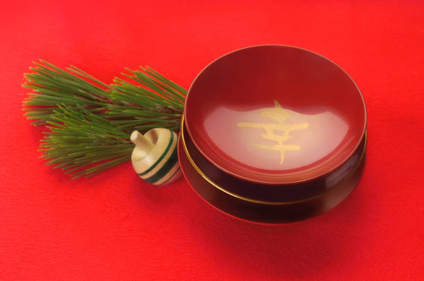 image for a new year day with sake cups on the red background/Studio Shot
