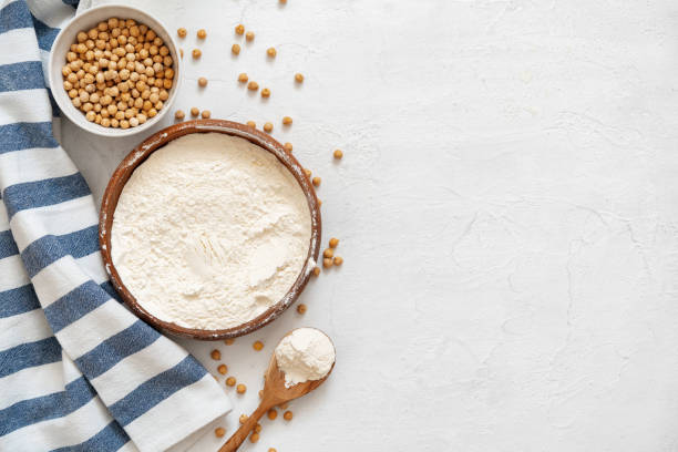 Chickpea and flour in ceramic bowl on white background