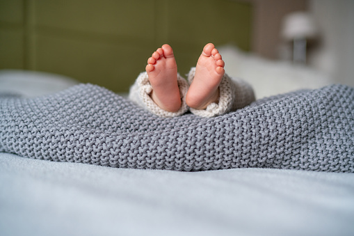 Baby feet in the air. Feet of newborn baby. Happy family and parenthood concept.