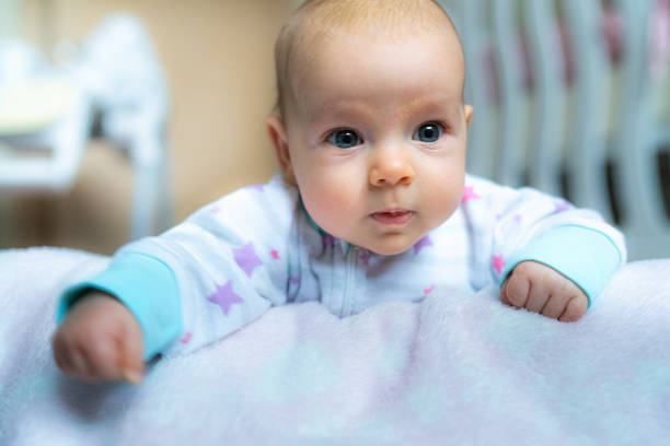 Cute baby girl lying in crib