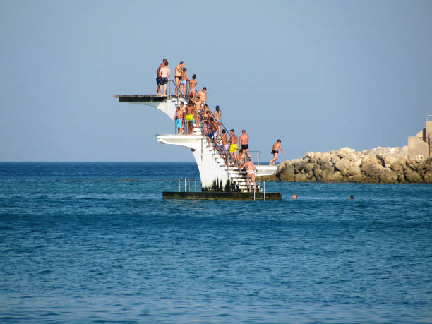 Rhodes, Greece - 7.6.2009: Tourists on a sea divingboard in Rhodes beach