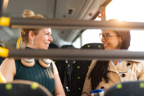 istock Two woman on the way to work talking in bus 1402855210