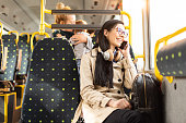 Woman talking on mobile phone in bus