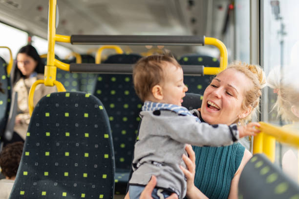 Happy mother and son traveling by bus