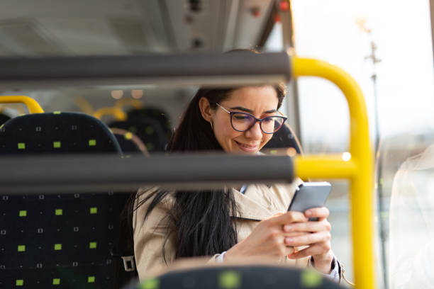 istock Woman traveling by bus and using smart phone 1402855945
