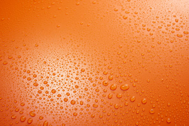 Water droplets on the glass with a colored background. Drops of water.