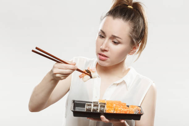 istock woman with sushi 1402859763